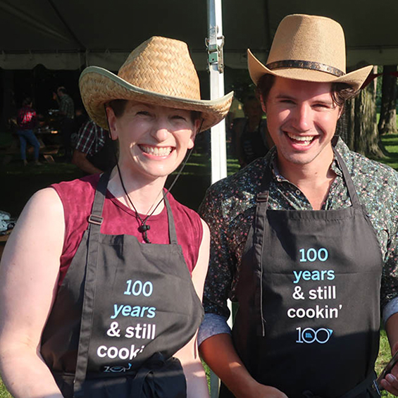 Employees in cowboy hats and aprons at stampede breakfast.