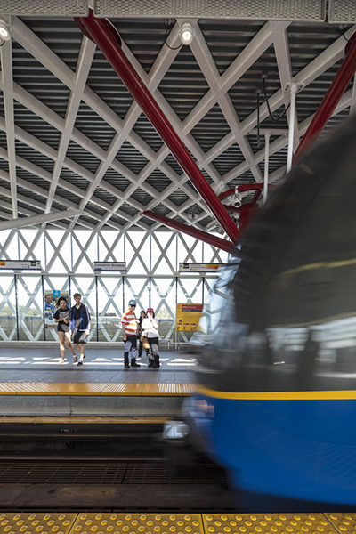 Two People waiting at the Platform of Commercial Broadway Station