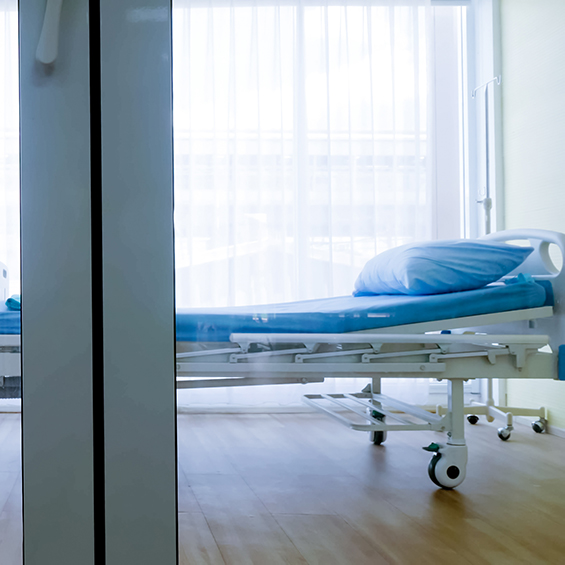 Bedroom for patient in a hospital, Empty bed and wheelchair on hospital ward