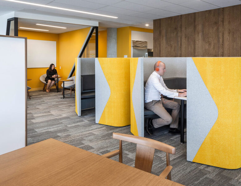 AstraZeneca_02-1560x1206 Modern interior cubicle with yellow details and man at workstation