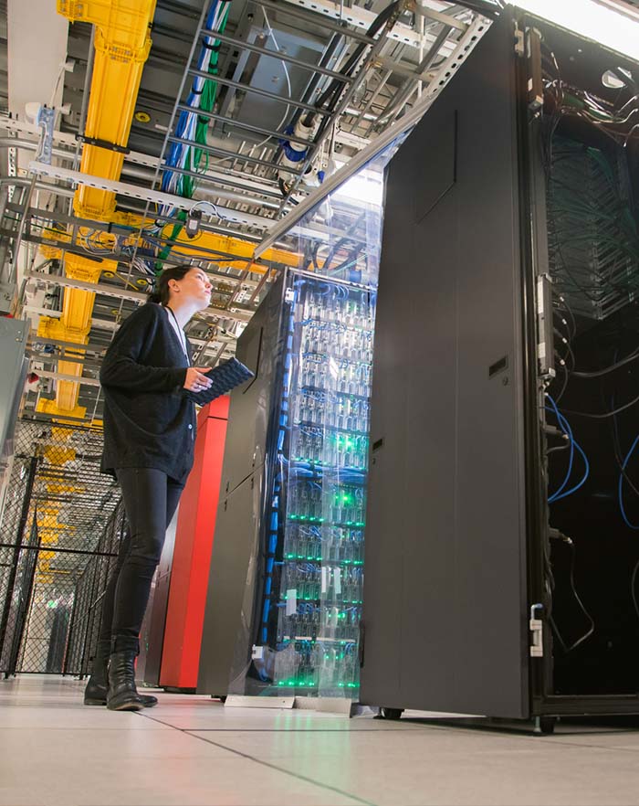 Image of woman technician looking after modern server room Image of woman technician looking after modern server room