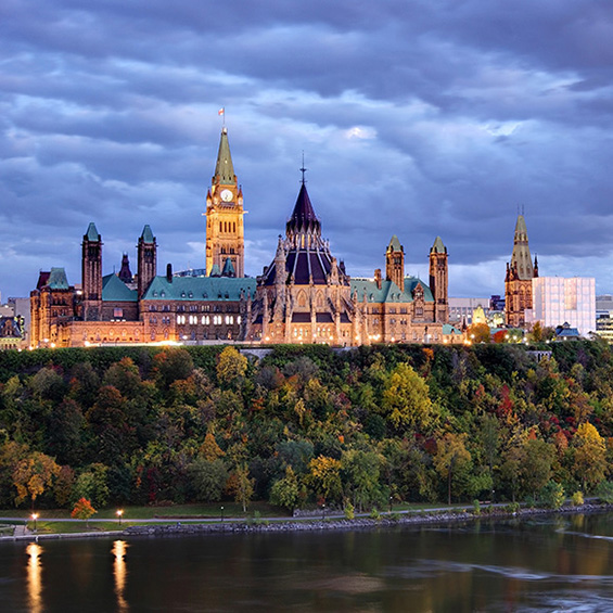 Parliament Hill atop a dramatic hill overlooking the Ottawa River in Ottawa, Ontario in autumn. Parliament Hill is home to Canada's federal government and is the centrepiece of Ottawa’s downtown landscape. Ottawa is known for is high-tech business sector, vast array of museums and high standard of living.