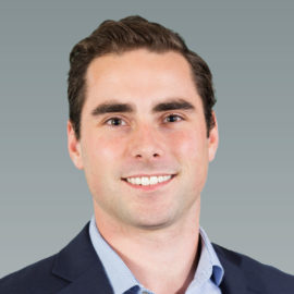Zoomed in headshot of Ben Debruyne with grey background.