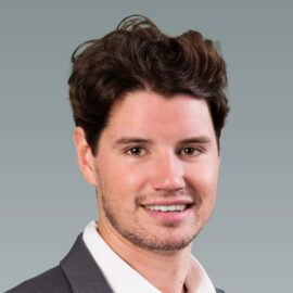 Perry Dayne_5x7_grey_background Headshot of Dayne Perry with a grey background.