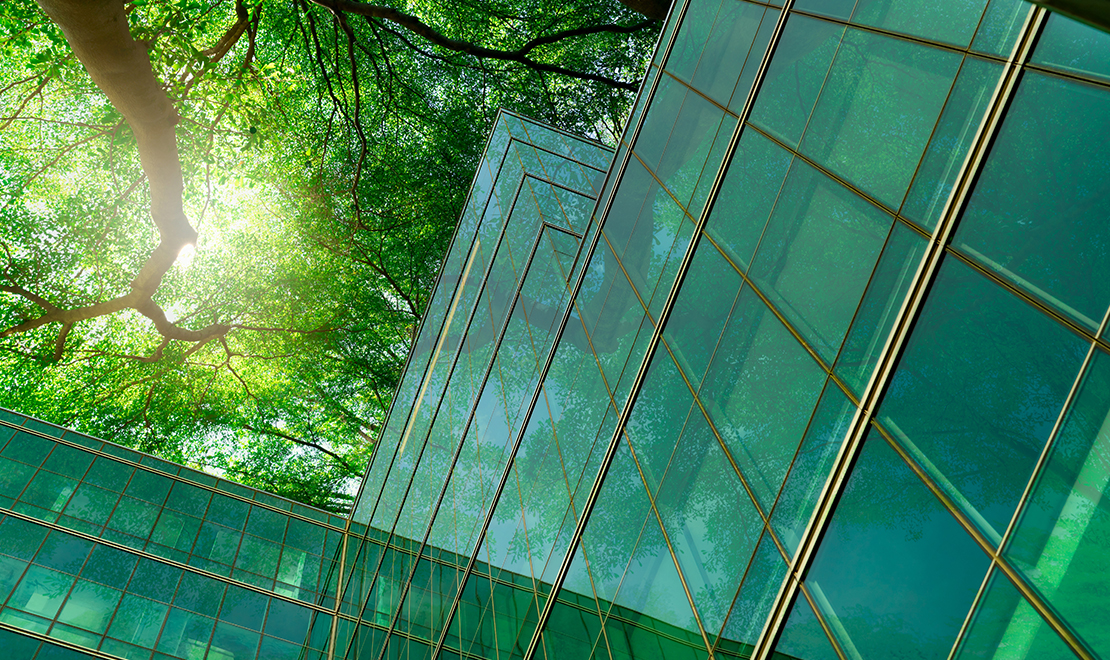 CaGBC - Building Lasting Change Image of trees reflected in glass office building