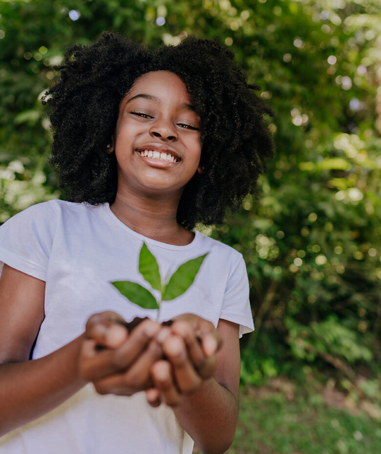 Child holding a small tree sapling Child holding a small tree sapling