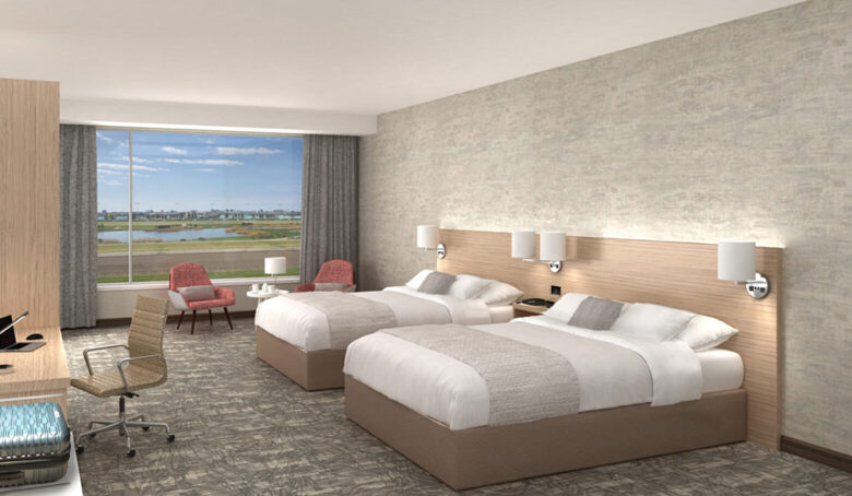 View-9-Hotel-Room-scaled-1560x908 Image of a modern hotel room with 2 beds and scenic view
