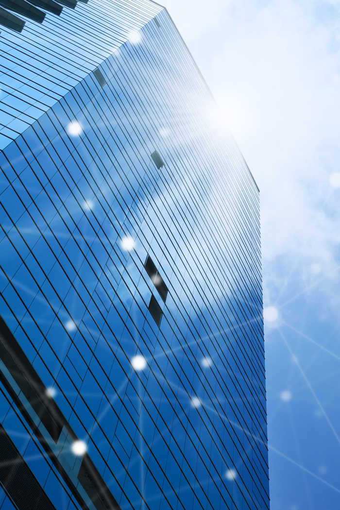 AC_About_Land Modern commercial tower with connectivity graphics overlay